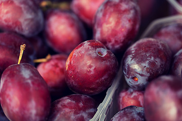 Image showing close up of satsuma plums in box at street market