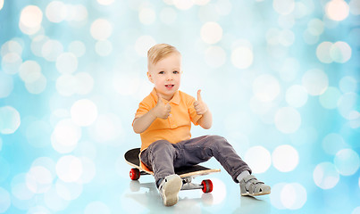 Image showing happy little boy on skateboard showing thumbs up