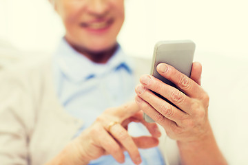 Image showing close up of senior woman with smartphone texting