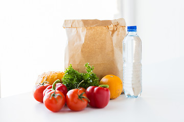 Image showing close up of paper bag with vegetables and water