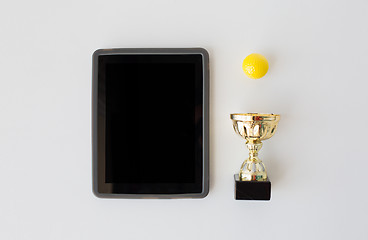 Image showing close up of golf ball, cup and tablet pc