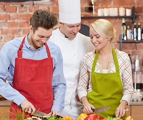 Image showing happy couple and male chef cook cooking in kitchen