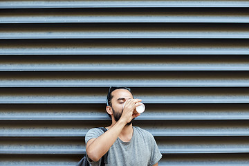 Image showing man drinking coffee from paper cup on street