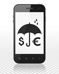 Image showing Safety concept: Smartphone with Money And Umbrella on display