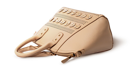 Image showing Elegant leather beige handbag lying