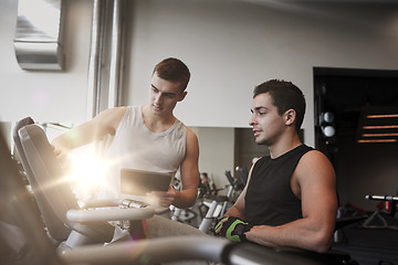 Image showing men exercising on gym machine