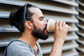 Image showing man drinking coffee from paper cup on street