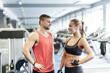 Image showing smiling man and woman talking in gym