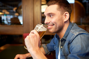 Image showing happy man drinking draft beer at bar or pub