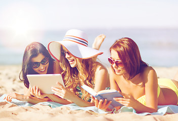 Image showing girls with tablet pc on the beach