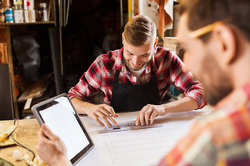 Image showing workmen with tablet pc and blueprint at workshop