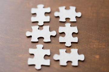 Image showing close up of puzzle pieces on wooden surface