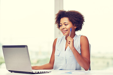 Image showing happy african woman with laptop at office