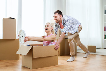 Image showing couple with cardboard boxes having fun at new home