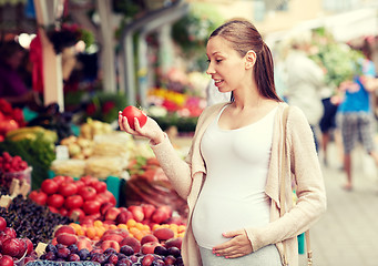 Image showing pregnant woman choosing food at street market