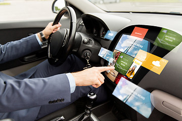 Image showing man driving car with news on board computer