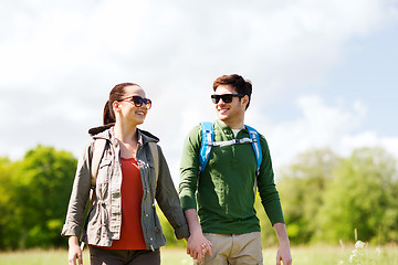 Image showing happy couple with backpacks hiking outdoors