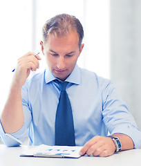 Image showing businessman writing in notebook