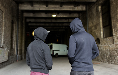 Image showing addict men or criminals in hoodies on street