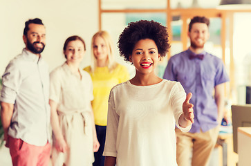 Image showing woman making handshake over creative office team