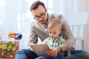 Image showing father and son with tablet pc playing at home