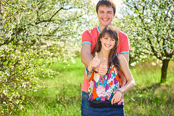 Image showing Young couple enjoying in blooming garden