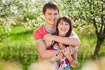 Image showing Young couple enjoying in blooming garden