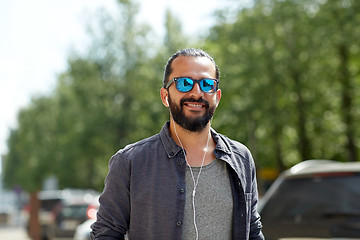 Image showing man with earphones listening to music in city