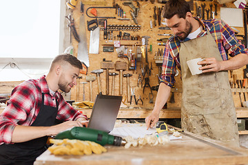 Image showing carpenters with laptop and blueprint at workshop