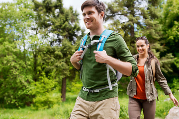 Image showing happy couple with backpacks hiking outdoors