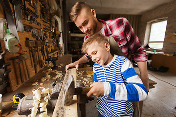 Image showing father and son with hammer working at workshop