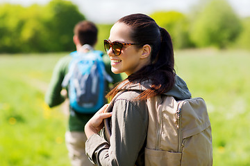 Image showing happy couple with backpacks hiking outdoors