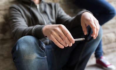 Image showing close up of young man smoking cigarette