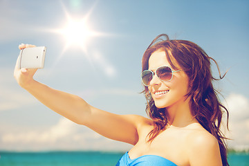 Image showing woman in bikini with phone