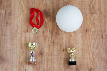 Image showing close up of volleyball ball, cups and medals