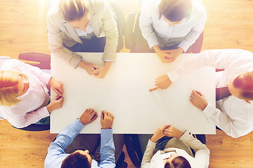 Image showing close up of business team sitting at table