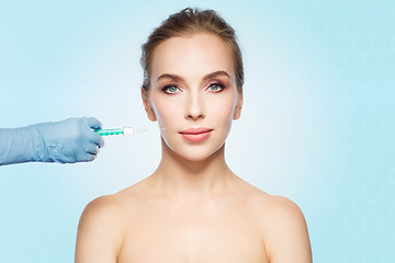 Image showing woman face and hand with syringe making injection