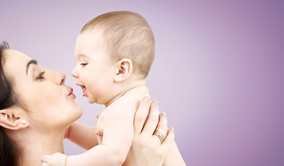 Image showing happy mother kissing adorable baby