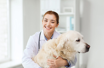 Image showing happy doctor with retriever dog at vet clinic