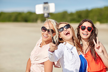 Image showing group of smiling women taking selfie on beach