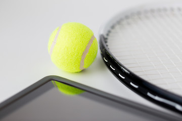 Image showing close up of tennis racket with ball and tablet pc