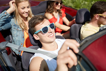 Image showing happy friends driving in cabriolet car