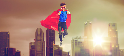 Image showing boy in superhero cape and mask showing thumbs up