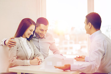 Image showing couple looking at model of their house at office