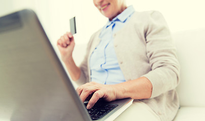 Image showing senior woman with laptop and credit card at home