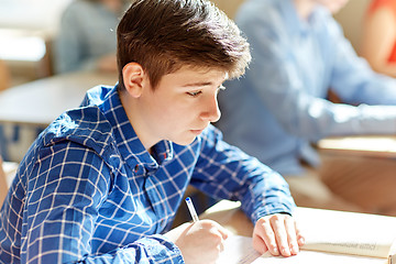 Image showing group of students with books writing school test