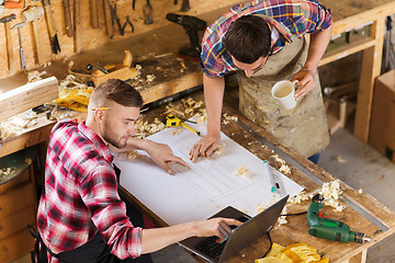 Image showing carpenters with laptop and blueprint at workshop