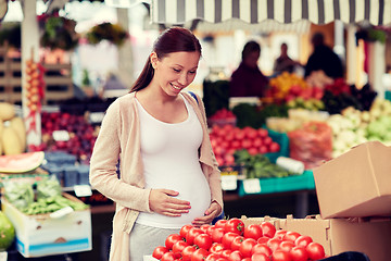 Image showing pregnant woman choosing food at street market