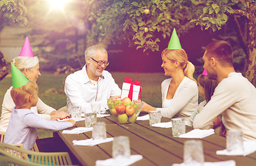 Image showing happy family having holiday dinner outdoors