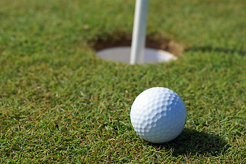 Image showing Golfball in front of the hole